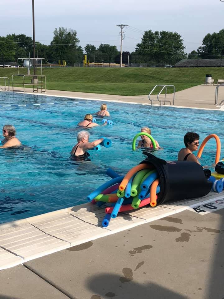 senior swimming in pool